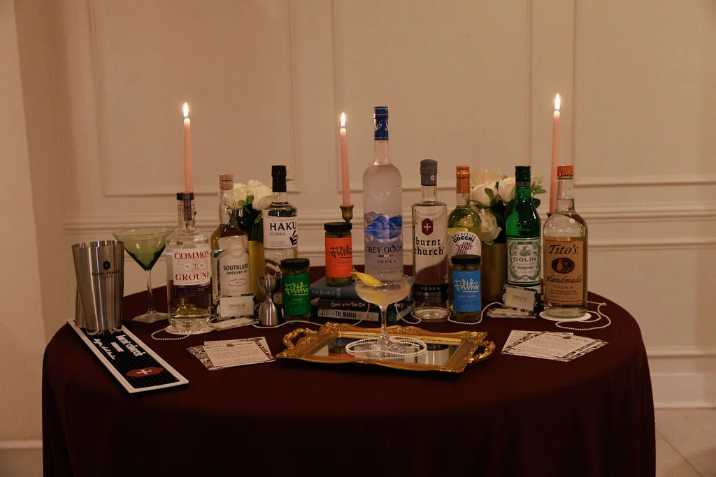 Event bar package setup with spirits, cocktail menu, and garnishes