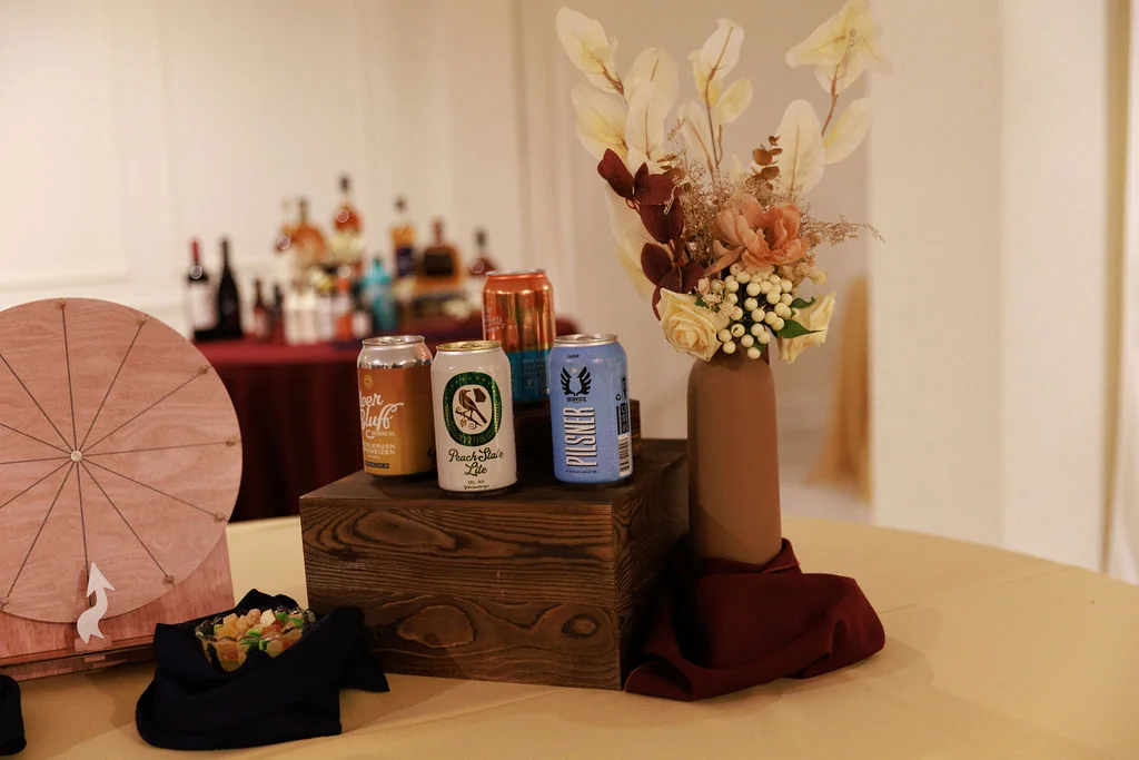Branded private event bar display with canned cocktails and decor