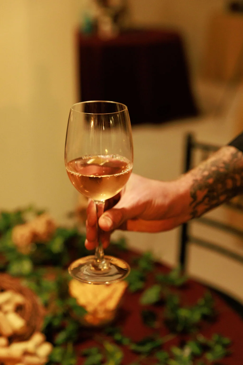 Sparkling toast moment with a raised wine glass at a Formosa Bar event