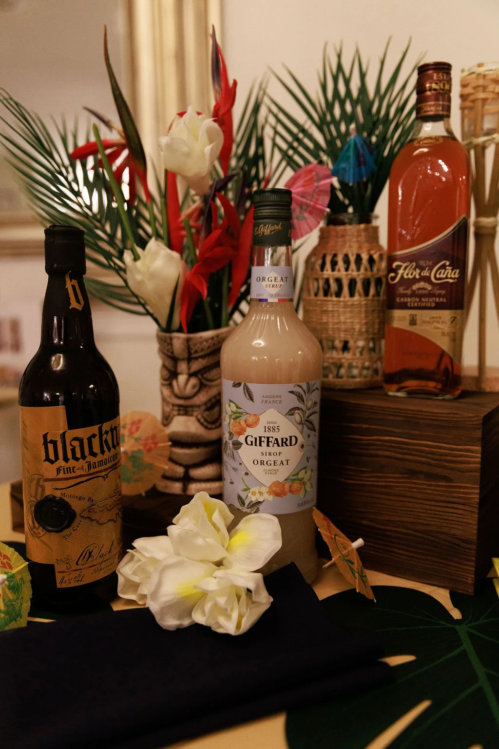 Tropical tiki bar station with rum bottles and island-style decor